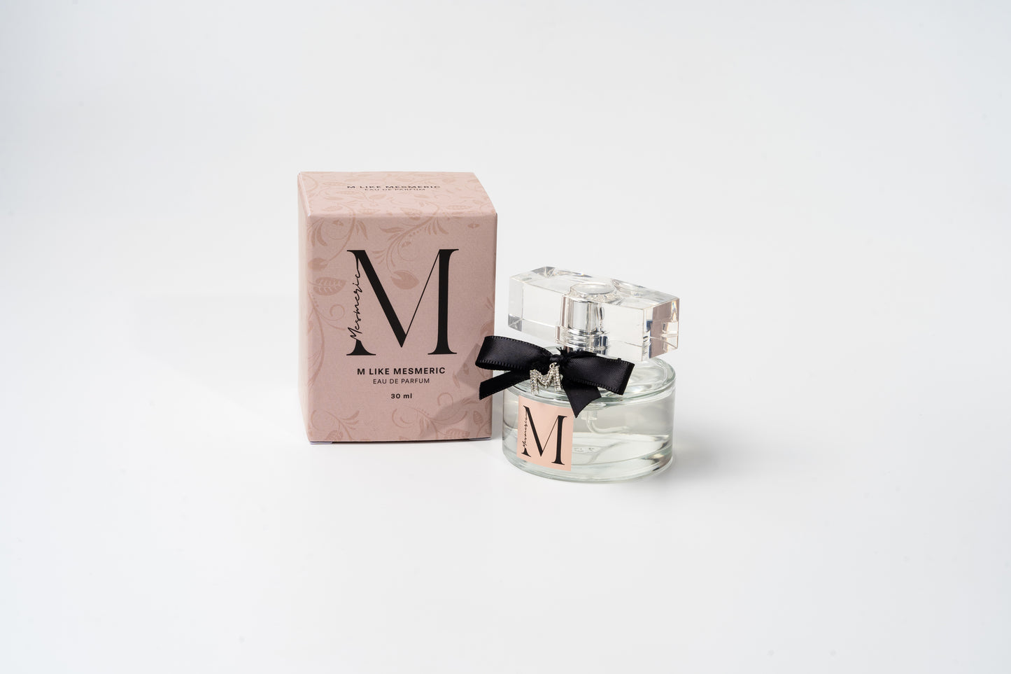 A bottle of M like Mesmeric parfume and its box.